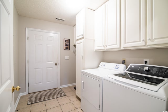 174 Edward Ave, Murrells Inlet, SC 29576 - laundry area featuring cabinet space, separate washer and dryer, light tile patterned floors, and a textured ceiling