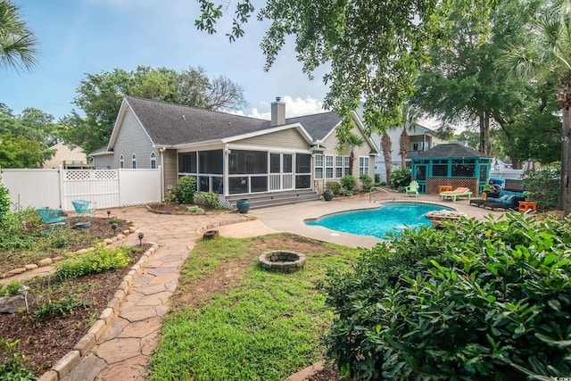 174 Edward Ave, Murrells Inlet, SC 29576 - view of swimming pool featuring a sunroom, an outdoor fire pit, and a patio area
