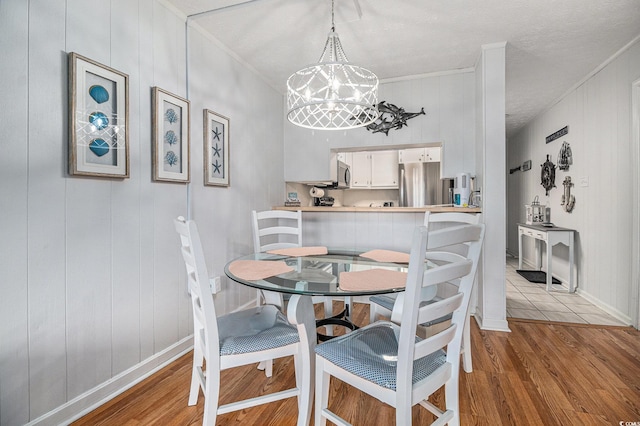 9501 Shore Dr Unit 135, Myrtle Beach, SC 29572 - dining space with wood finished floors, a chandelier, and ornamental molding