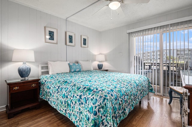 9501 Shore Dr Unit 135, Myrtle Beach, SC 29572 - bedroom with wood finished floors, a textured ceiling, a ceiling fan, and access to outside