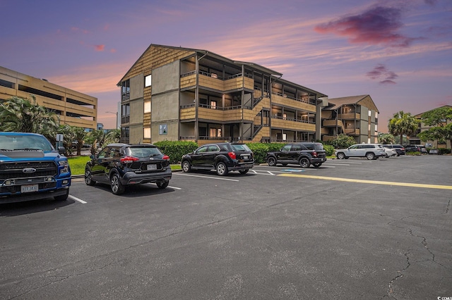 9501 Shore Dr Unit 135, Myrtle Beach, SC 29572 - property at dusk with uncovered parking