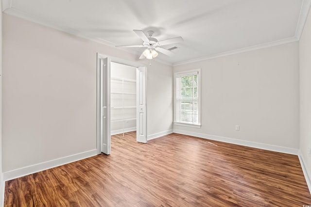 1032 Chelsey Cir, Conway, SC 29526 - unfurnished bedroom featuring ornamental molding, a closet, wood finished floors, a spacious closet, and ceiling fan