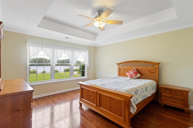 2210 Haystack Way, Myrtle Beach, SC 29579 - bedroom featuring a tray ceiling, dark wood-style flooring, a water view, a ceiling fan, and ornamental molding