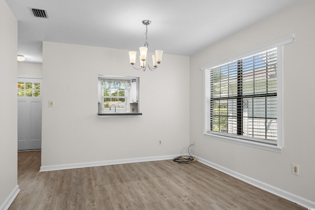 6576 Pebble Beach Cres, Myrtle Beach, SC 29588 - unfurnished room with wood finished floors, a chandelier, and plenty of natural light