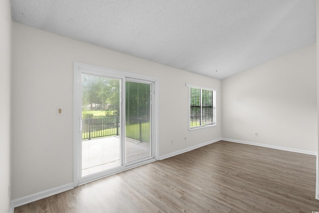 6576 Pebble Beach Cres, Myrtle Beach, SC 29588 - empty room featuring wood finished floors, a textured ceiling, and lofted ceiling