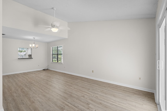 6576 Pebble Beach Cres, Myrtle Beach, SC 29588 - spare room featuring light wood-type flooring, a chandelier, a ceiling fan, and vaulted ceiling