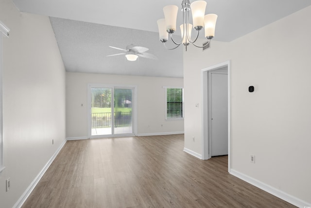 6576 Pebble Beach Cres, Myrtle Beach, SC 29588 - unfurnished room featuring wood finished floors, a ceiling fan, a chandelier, and vaulted ceiling