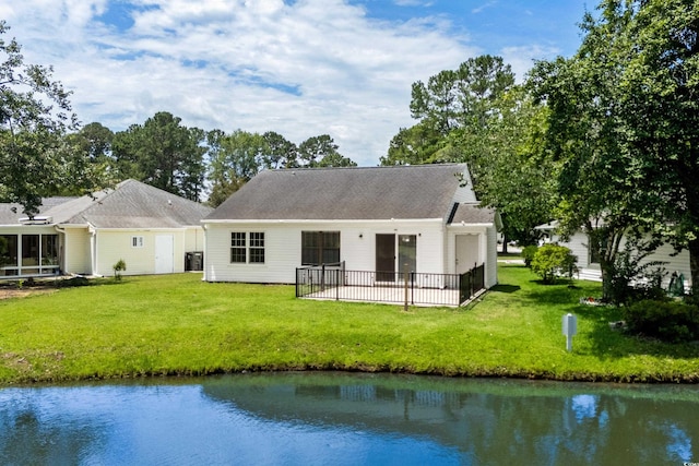 6576 Pebble Beach Cres, Myrtle Beach, SC 29588 - back of house featuring a patio area, a lawn, and a water view