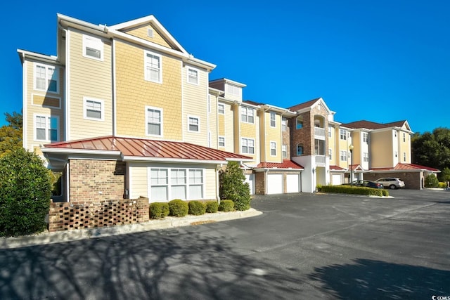 5650 Barefoot Resort Bridge Rd Unit 431, North Myrtle Beach, SC 29582 - view of front of home with a standing seam roof, brick siding, and a residential view