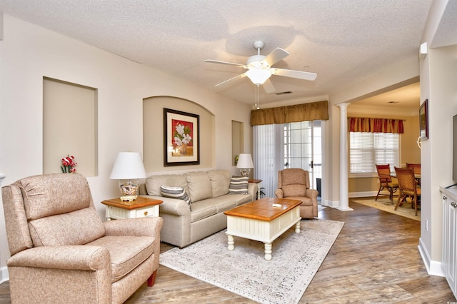 5650 Barefoot Resort Bridge Rd Unit 431, North Myrtle Beach, SC 29582 - living room with ceiling fan, wood finished floors, a textured ceiling, and ornate columns