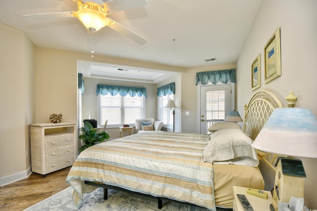 5650 Barefoot Resort Bridge Rd Unit 431, North Myrtle Beach, SC 29582 - bedroom featuring multiple windows, wood finished floors, and a ceiling fan