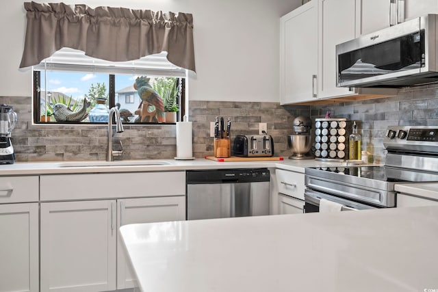 775 Plantation Dr Unit 53, Little River, SC 29566 - kitchen with appliances with stainless steel finishes, light countertops, white cabinets, and decorative backsplash