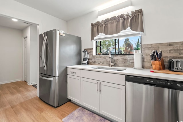 775 Plantation Dr Unit 53, Little River, SC 29566 - kitchen with stainless steel appliances, light wood-style flooring, light countertops, and decorative backsplash