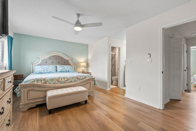 775 Plantation Dr Unit 53, Little River, SC 29566 - bedroom with light wood-style flooring, connected bathroom, a textured ceiling, and ceiling fan
