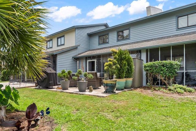 775 Plantation Dr Unit 53, Little River, SC 29566 - back of property with a patio, a lawn, a chimney, and a sunroom