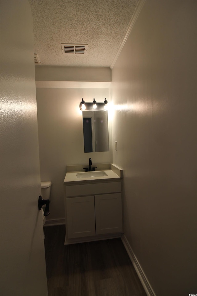 950 Forestbrook Rd Unit B-8, Myrtle Beach, SC 29588 - bathroom with a textured ceiling, vanity, wood finished floors, and ornamental molding