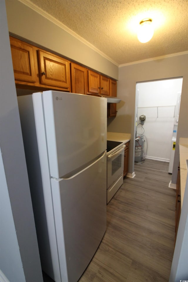 950 Forestbrook Rd Unit B-8, Myrtle Beach, SC 29588 - kitchen featuring white appliances, brown cabinets, ornamental molding, a textured ceiling, and light countertops