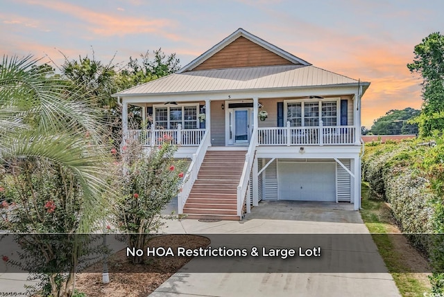 5 Tiara Ln, Murrells Inlet, SC 29576 - coastal home with covered porch, stairs, an attached garage, driveway, and a metal roof