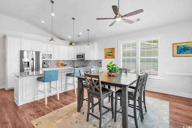 5 Tiara Ln, Murrells Inlet, SC 29576 - dining area featuring a ceiling fan, vaulted ceiling, wood finished floors, and recessed lighting