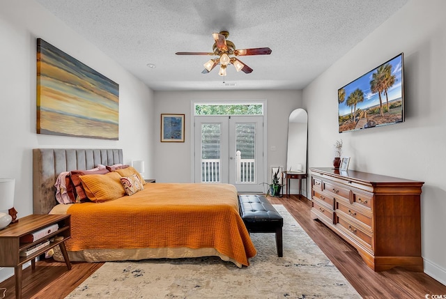 5 Tiara Ln, Murrells Inlet, SC 29576 - bedroom featuring access to outside, wood finished floors, a textured ceiling, arched walkways, and ceiling fan