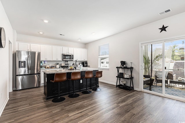 651 Choctaw Dr, Conway, SC 29526 - kitchen with stainless steel appliances, dark wood-style floors, a kitchen island with sink, white cabinets, and recessed lighting