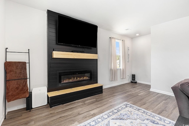 651 Choctaw Dr, Conway, SC 29526 - unfurnished living room with wood finished floors, a large fireplace, and recessed lighting