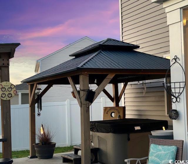 651 Choctaw Dr, Conway, SC 29526 - patio terrace at dusk with a gazebo and a hot tub