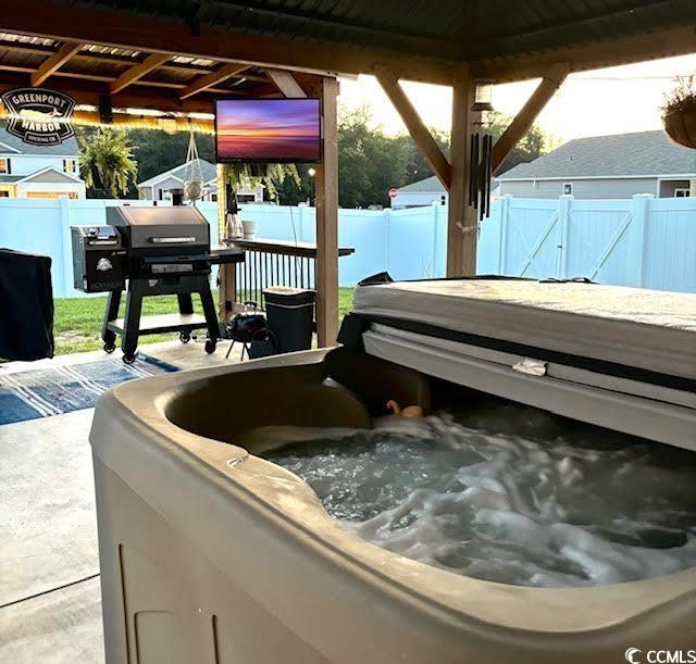 651 Choctaw Dr, Conway, SC 29526 - fenced backyard with a hot tub and area for grilling