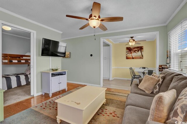 6001-1459 S Kings Hwy, Myrtle Beach, SC 29575 - living room with light wood finished floors, a ceiling fan, ornamental molding, and a textured ceiling
