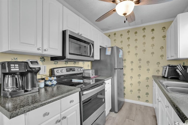 6001-1459 S Kings Hwy, Myrtle Beach, SC 29575 - kitchen featuring stainless steel appliances, wallpapered walls, light wood-type flooring, white cabinetry, and ceiling fan