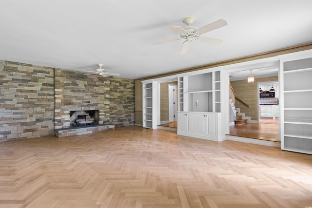 571 Fernwood Rd, Murrells Inlet, SC 29576 - unfurnished living room with a ceiling fan, stairway, a fireplace, and built in shelves