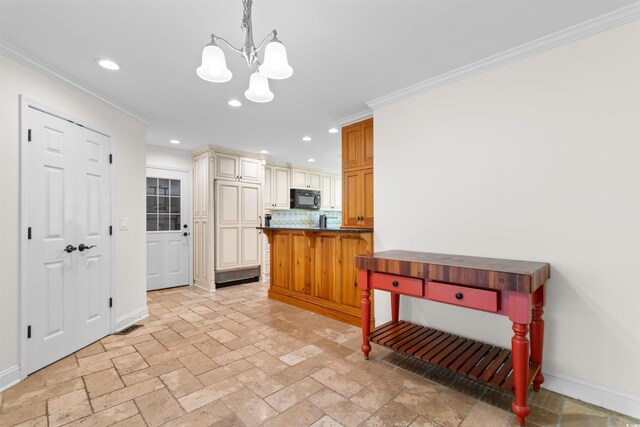 571 Fernwood Rd, Murrells Inlet, SC 29576 - kitchen with cream cabinets, black microwave, a chandelier, tasteful backsplash, and ornamental molding