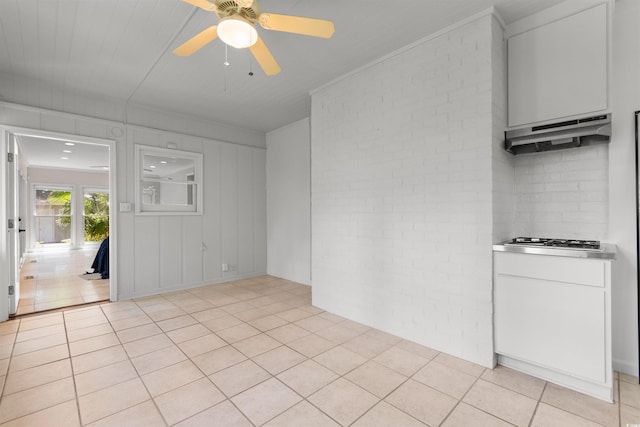 571 Fernwood Rd, Murrells Inlet, SC 29576 - empty room featuring brick wall, ceiling fan, light tile patterned floors, and crown molding