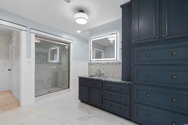 571 Fernwood Rd, Murrells Inlet, SC 29576 - full bath with a marble finish shower, marble look tiles, wainscoting, and double vanity