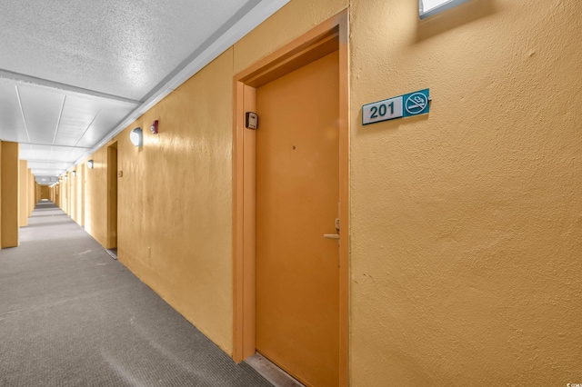 6900 N Ocean Blvd Unit 201, Myrtle Beach, SC 29572 - hall with carpet flooring, a textured wall, and a textured ceiling