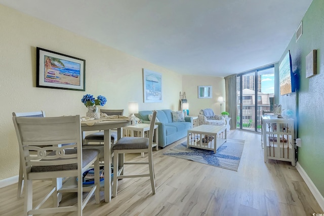 9550 Shore Dr Unit 225, Myrtle Beach, SC 29572 - living room with wood finished floors, floor to ceiling windows, and a textured wall