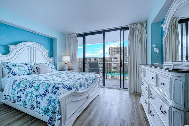 9550 Shore Dr Unit 225, Myrtle Beach, SC 29572 - bedroom featuring access to exterior, multiple windows, light wood finished floors, and expansive windows