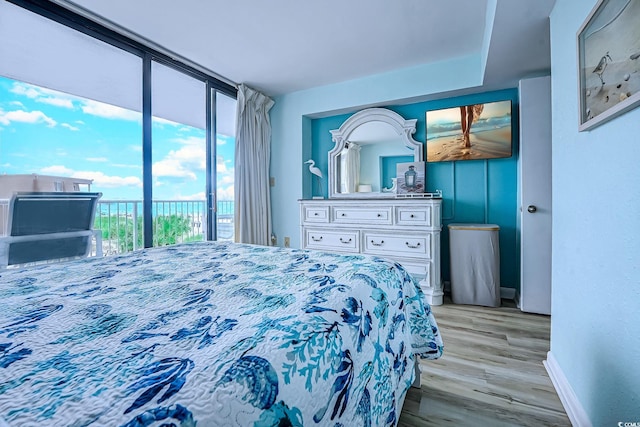 9550 Shore Dr Unit 225, Myrtle Beach, SC 29572 - bedroom featuring access to exterior, light wood-style flooring, and a water view