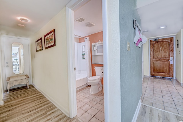 9550 Shore Dr Unit 225, Myrtle Beach, SC 29572 - hall with arched walkways, light tile patterned flooring, and a textured wall