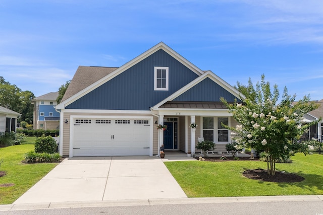 264 Switchgrass Loop, Little River, SC 29566 - view of front of property with a front lawn, driveway, a garage, and covered porch