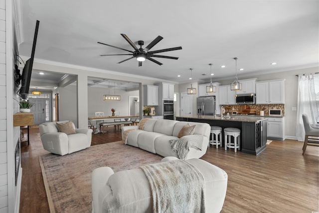 264 Switchgrass Loop, Little River, SC 29566 - living room with light wood finished floors, crown molding, a ceiling fan, and recessed lighting