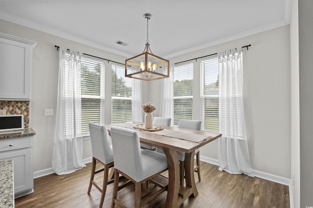 264 Switchgrass Loop, Little River, SC 29566 - dining room featuring a chandelier, plenty of natural light, wood finished floors, and crown molding