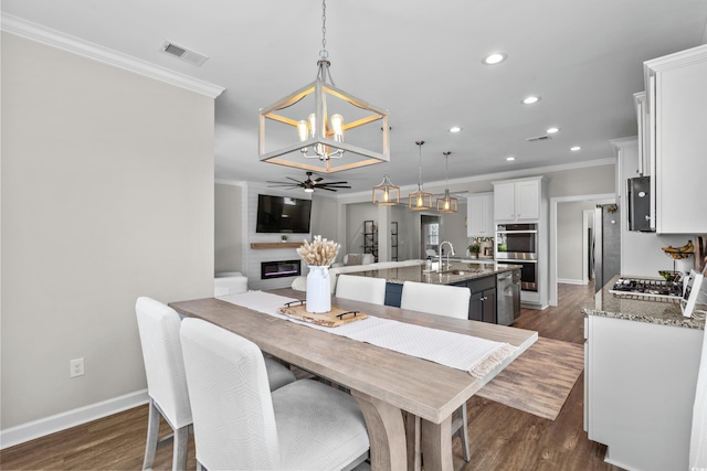 264 Switchgrass Loop, Little River, SC 29566 - dining area featuring a chandelier, recessed lighting, ceiling fan, dark wood-style flooring, and ornamental molding