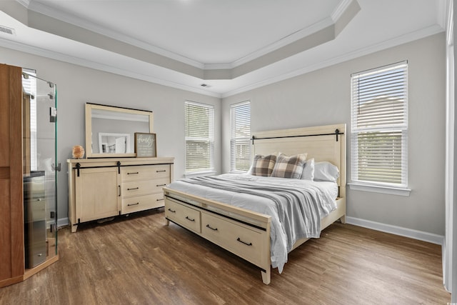 264 Switchgrass Loop, Little River, SC 29566 - bedroom featuring crown molding, dark wood-type flooring, and a tray ceiling