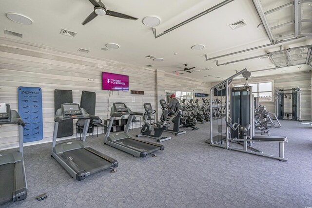264 Switchgrass Loop, Little River, SC 29566 - exercise room featuring a ceiling fan, a garage, and wooden walls