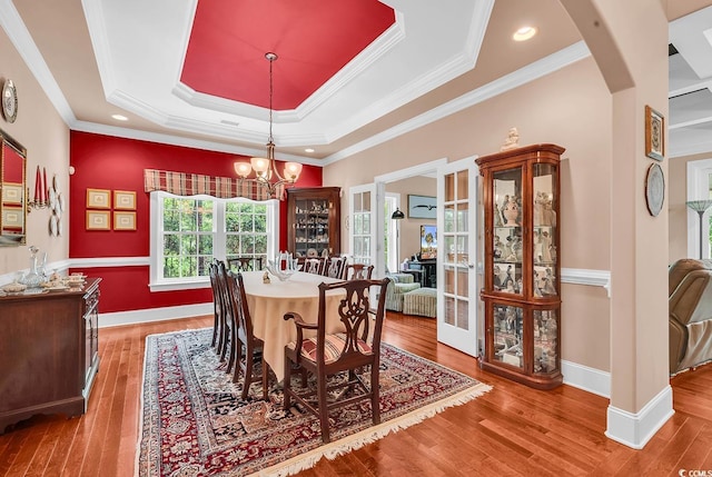 128 Knotty Pine Way, Murrells Inlet, SC 29576 - dining room featuring hardwood / wood-style flooring, arched walkways, a chandelier, a raised ceiling, and crown molding