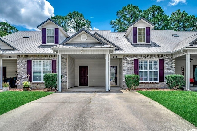 456 Colonial Trace Dr Unit 13-E, Longs, SC 29568 - view of front of property featuring concrete driveway, a front lawn, brick siding, and a metal roof