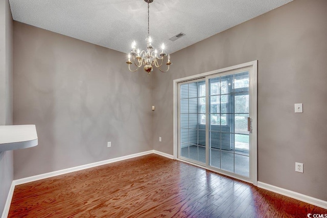 456 Colonial Trace Dr Unit 13-E, Longs, SC 29568 - unfurnished room featuring a chandelier, wood finished floors, and a textured ceiling