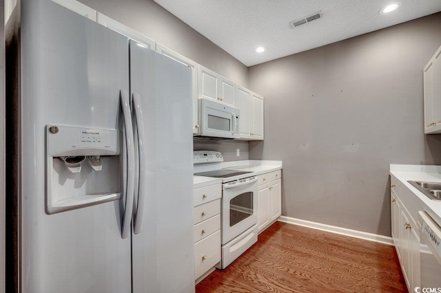 456 Colonial Trace Dr Unit 13-E, Longs, SC 29568 - kitchen featuring white appliances, white cabinets, light wood-style flooring, light countertops, and recessed lighting