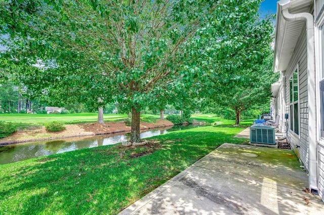 456 Colonial Trace Dr Unit 13-E, Longs, SC 29568 - view of green lawn with a water view, a patio, and view of wooded area